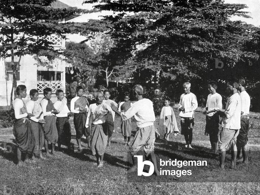 Thailand: A Siamese theatrical troupe preform a dance, c.1900. Women are on the left with sashes; men are on the right.