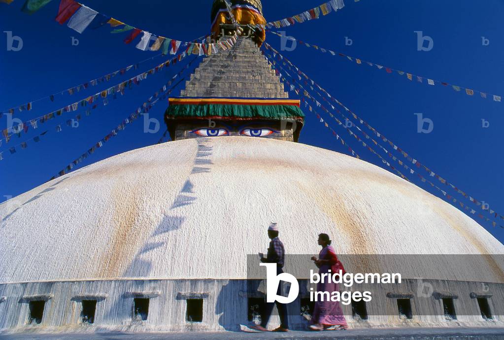 Nepal: Worshippers below the all-seeing eyes of the great dome of Bodhnath stupa, Kathmandu