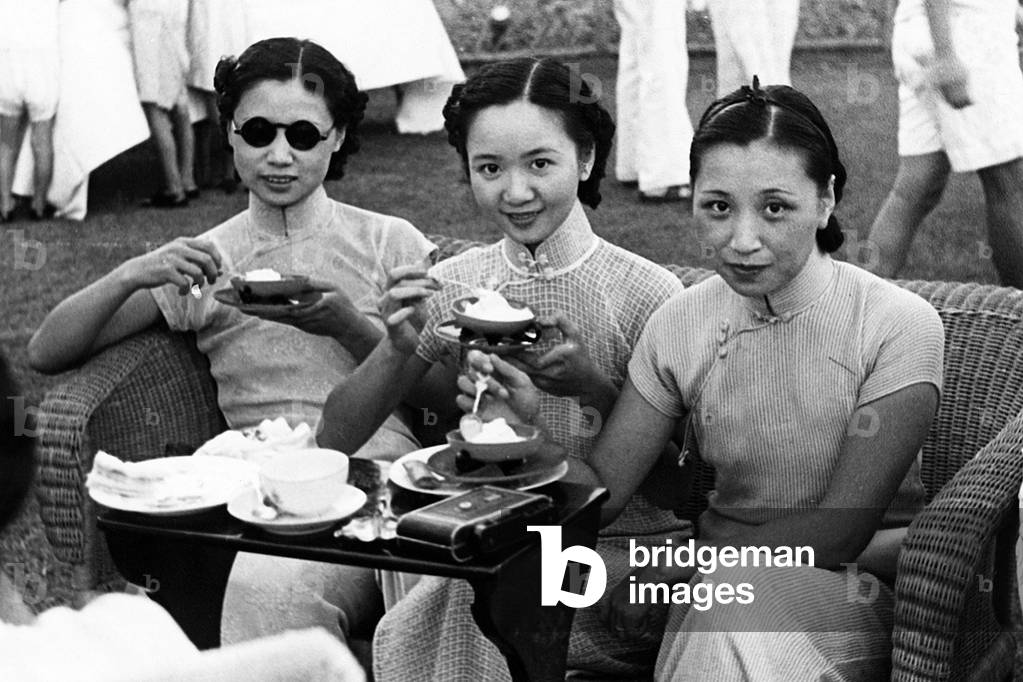 China: Three fashionable young women at a Shanghai International Settlement tennis match, c. 1935