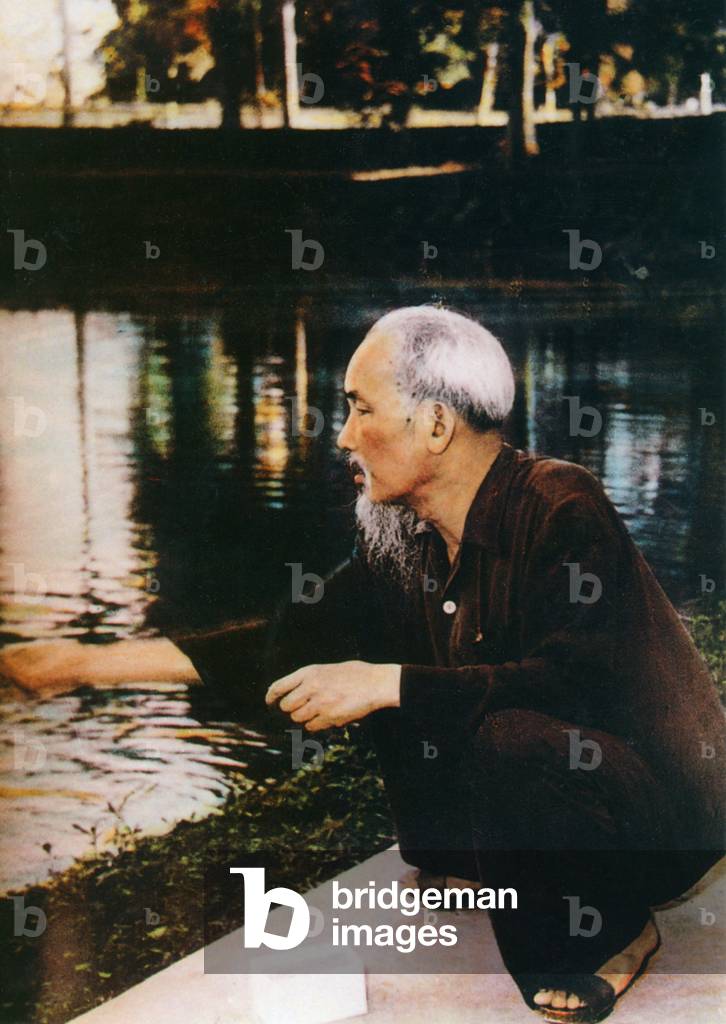 Vietnam: President Ho Chi Minh (1890-1969) feeding fish in the grounds of the Presidential Palace, Hanoi (1960)
