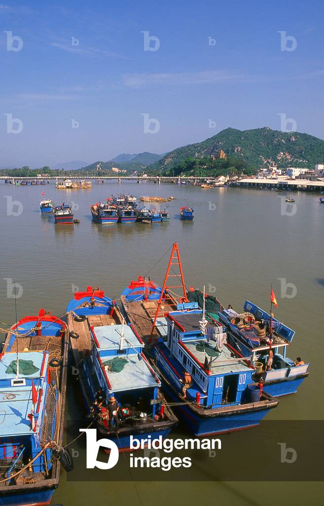 Vietnam: Fishing boats in the harbour, with the Po Nagar Cham Towers on the hill in the background, Nha Trang, Khanh Hoa Province