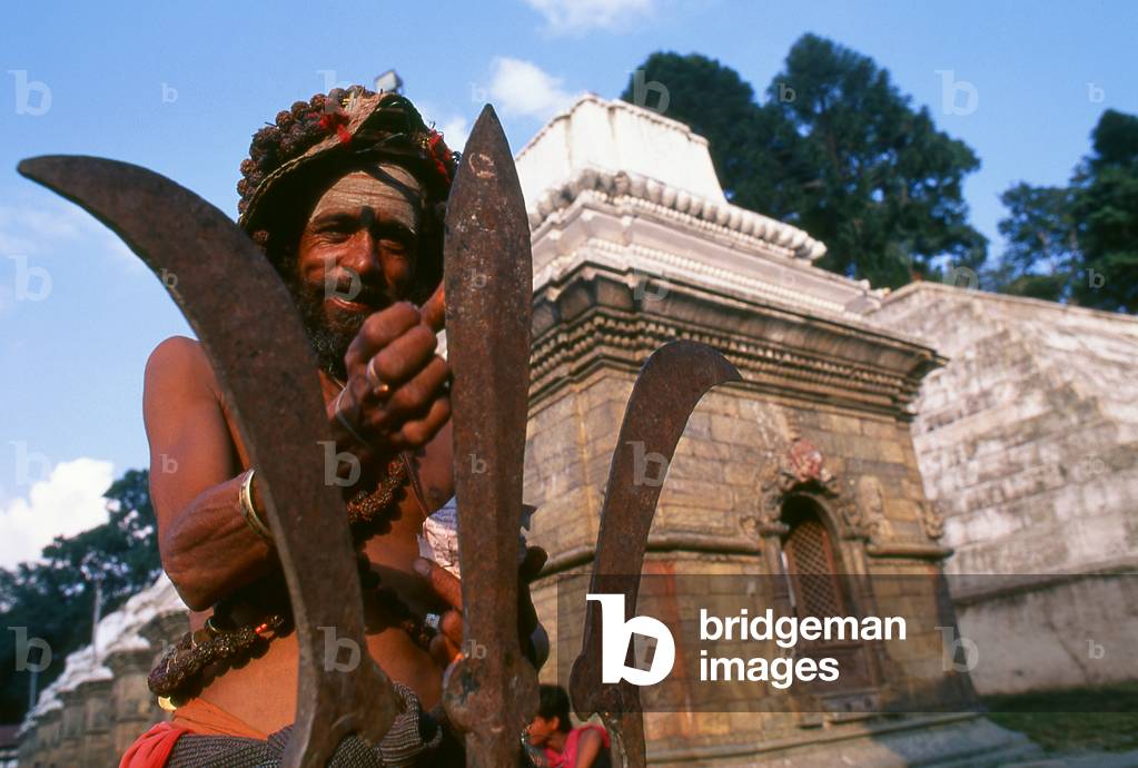 Nepal: Hashish-smoking sadhu with Shiva's trident (trishula), Pashupatinath, Kathmandu
