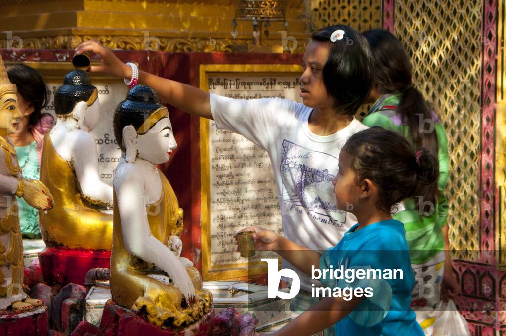 Burma / Myanmar: Bathing Buddha statues with water (a merit making act) in the Sutaungpyei Pagoda at the summit of Mandalay Hill, Mandalay