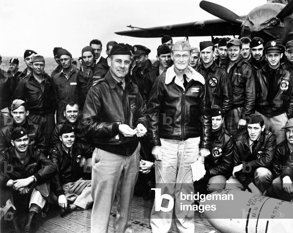 USA / Japan: Orders in hand, Navy Capt. Marc A. Mitscher, captain of the USS Hornet, poses with Lt. Col. James Doolittle and aircrew, north Pacific, April 1942
