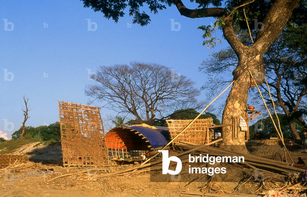 Burma / Myanmar: A worker's shelter, late afternoon on the Mandalay waterfront and the Irrawaddy River