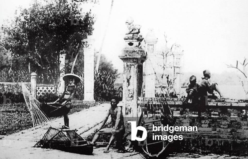 Vietnam:  Fishermen rest next to the Ho Tay (West Lake), Hanoi (early 20th century).