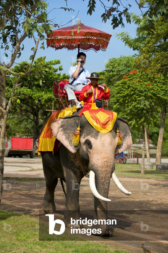 Thailand: Tourists on elephants in Ayutthaya Historical Park