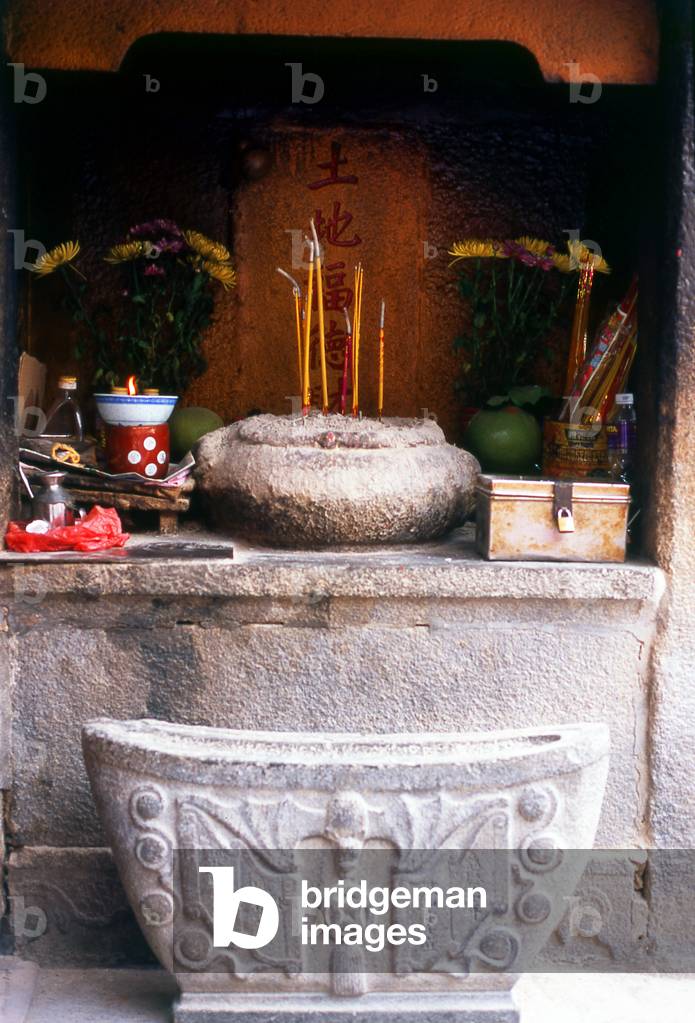 China: Incense burns in a corner shrine at the Taoist Temple da A-Ma, Macau
