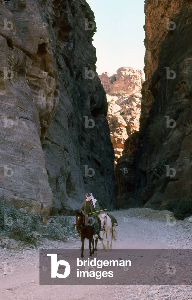 Jordan: Arab horseman in the Siq (shaft) leading to the ancient city of Petra