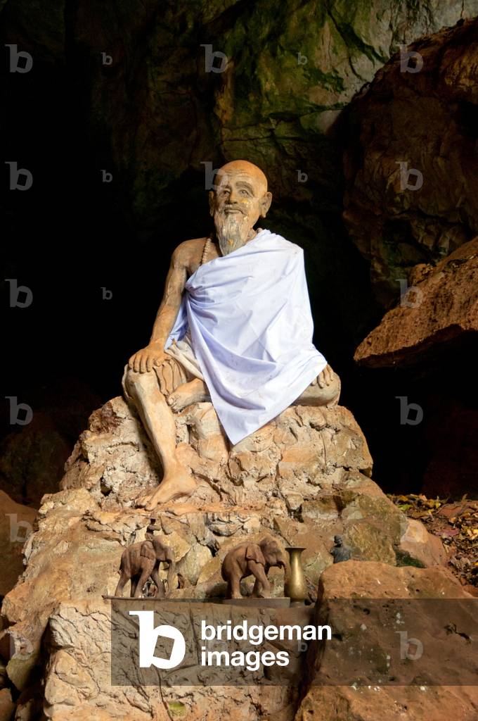 Thailand: Hermit figure inside the cave temple Wat Tham Suwankhuha, Phang Nga Province