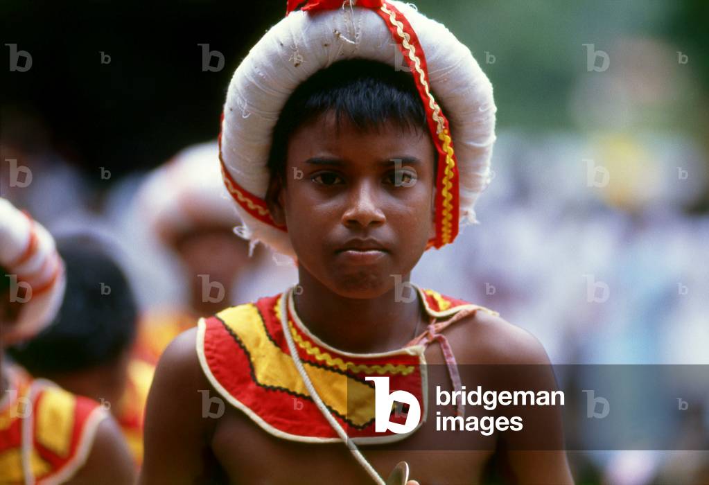 Sri Lanka: Traditional drummer boy at Kelani Temple near Colombo