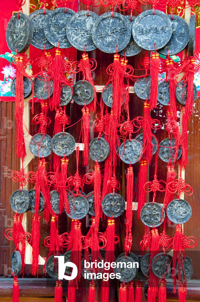 China: Solid blocks of tea hang as pendants outside a tea shop, Old Town, Lijiang, Yunnan Province