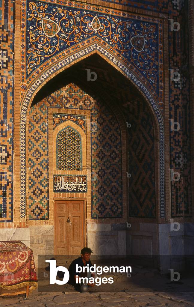 Uzbekistan: A man washes his hands in the inner courtyard of Tillya Kari Madrassa, The Registan, Samarkand