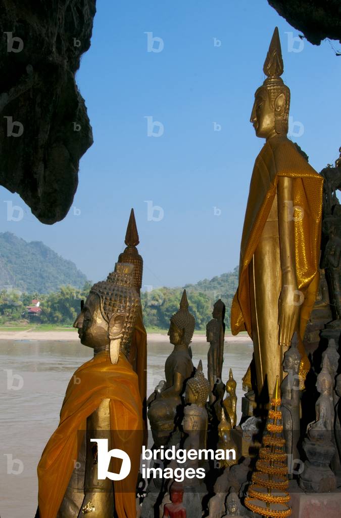 Laos: Buddha figures line the inside of the Pak Ou Caves overlooking the Mekong River, Luang Prabang