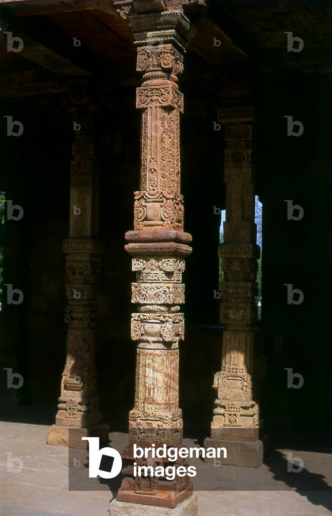 India: A crafted stone pillar in the Quwwat-ul-Islam Mosque at the ancient Qutb Minar complex, Delhi
