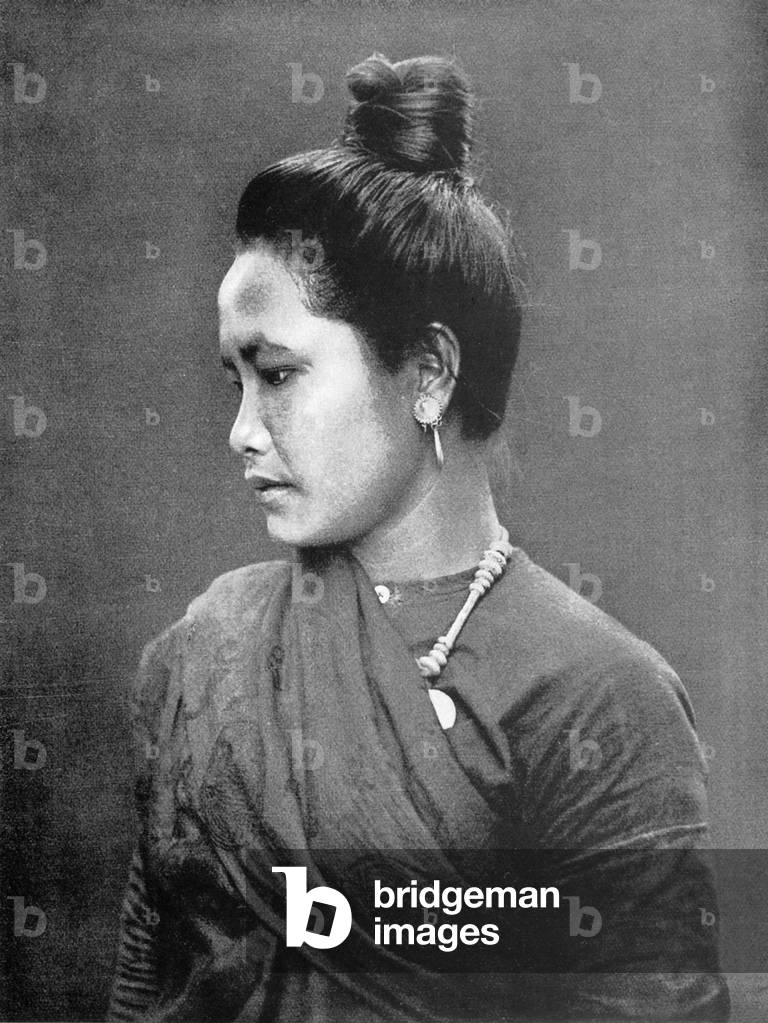 Thailand: A Northern Thai woman with her hair in a bun.