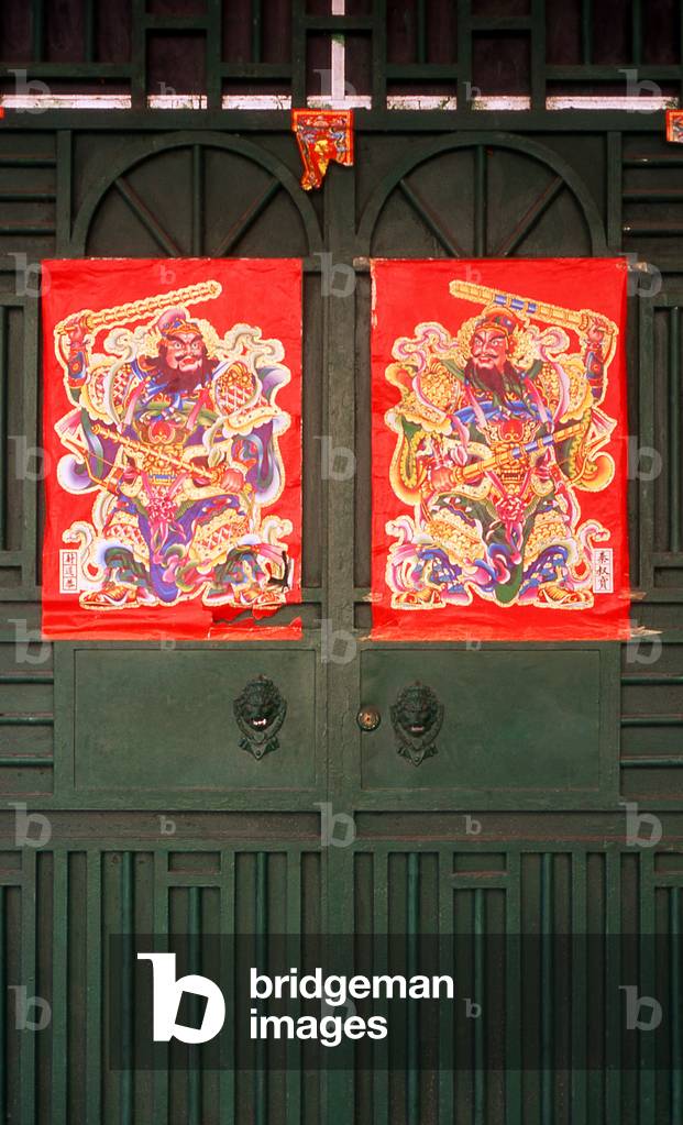 China: Protective warriors on the front doors of an old 1920s shophouse, Beihai, Guangxi Province