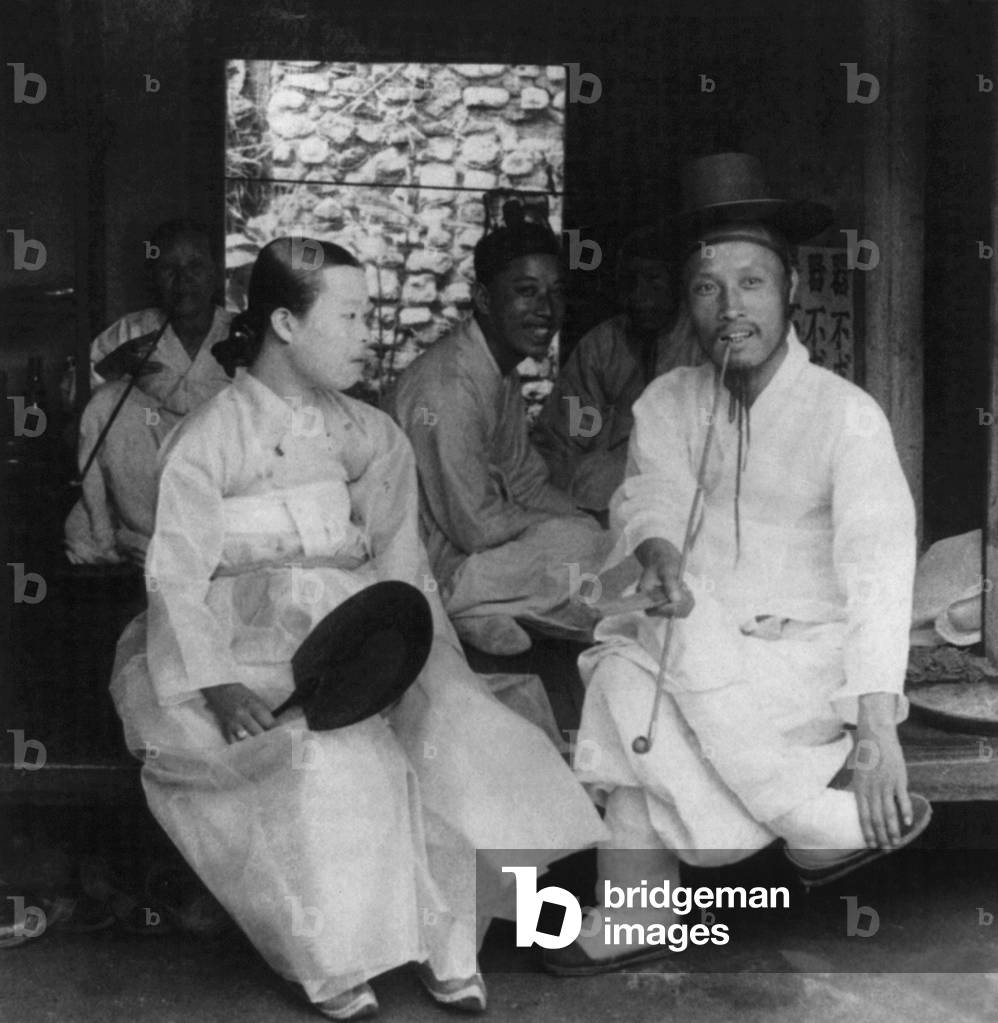 Korea: A Korean lady and her husband at their home, Seoul, early 20th century