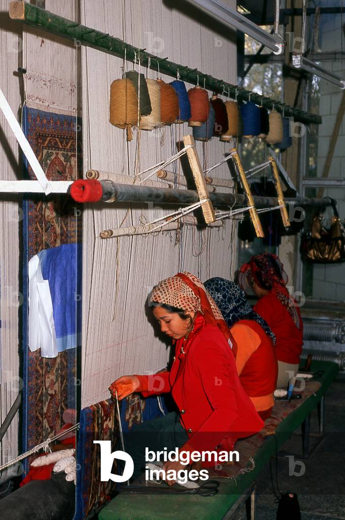 China: Uighur carpet weavers, carpet factory, Khotan, Xinjiang