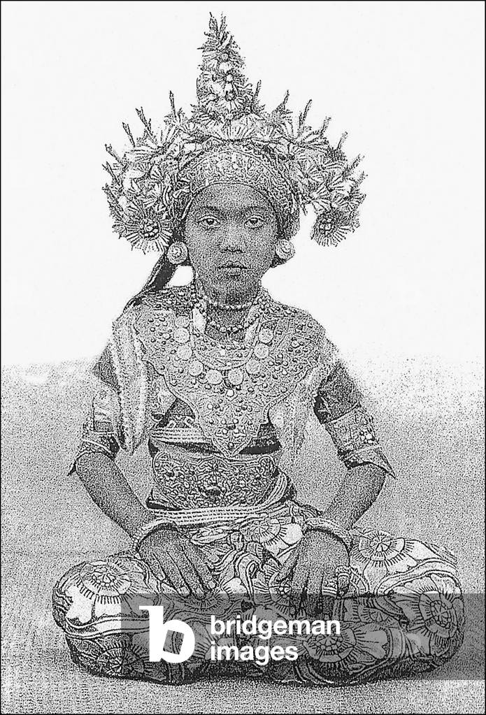 Indonesia: Balinese court dancer wearing a golden crown and elaborate jewellery (1928)