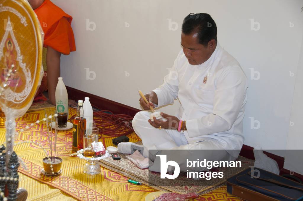 Thailand: Thai Buddhist ordination ceremony, Chiang Mai. A Brahman priest (all in white) joins the ordination proceedings. He is to present the nakor monks-to-be to the spirits, to let those spirits know that these young men are to become monks