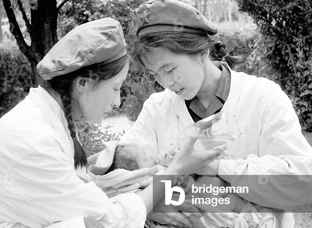 China: Two nurses care for an infant victim of the Great Tangshan Earthquake, 28 July 1976
