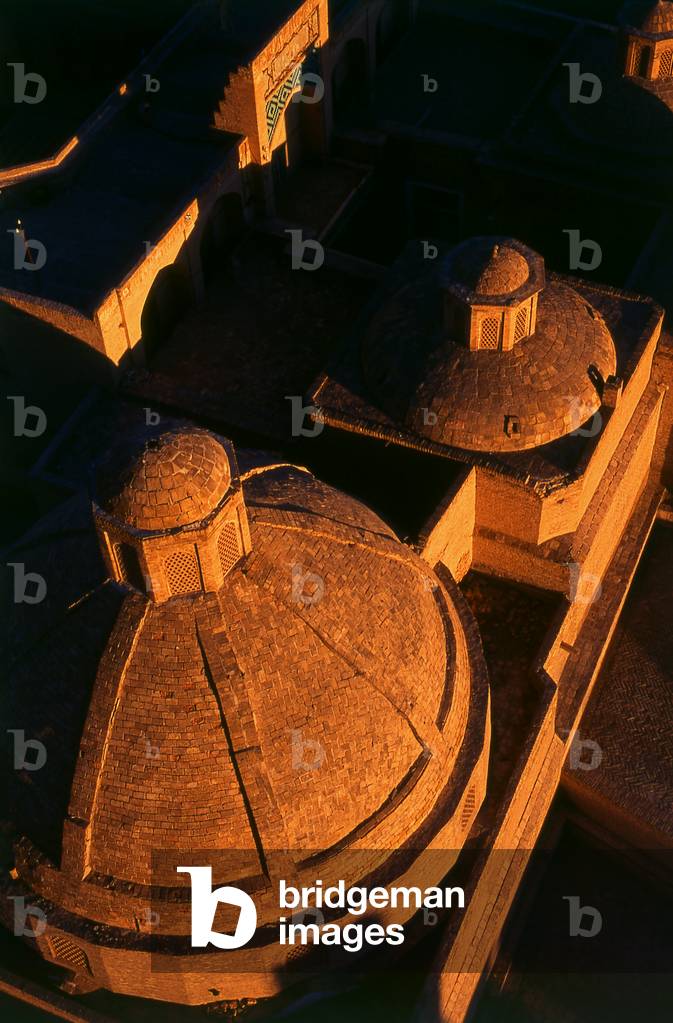 Uzbekistan: The sun sets on the  domes of the Amir Alim Khan Madrassa, Bukhara