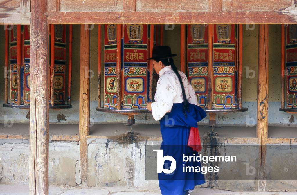 China: Pilgrims circumambulate the monastery while spinning the prayer wheels, Labrang Monastery, Xiahe, Gansu province