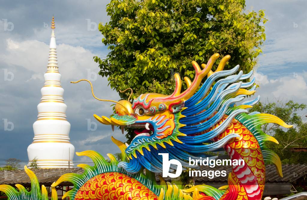 Thailand: Dragon with the chedi at Wat Tantayaphirom in the background, Kiuyong La Chinese shrine (joss house), Trang Town, Trang Province, southern Thailand