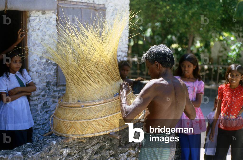 Maldives: Plaiting coconut leaf spines to make a food cover, the Outer Atolls