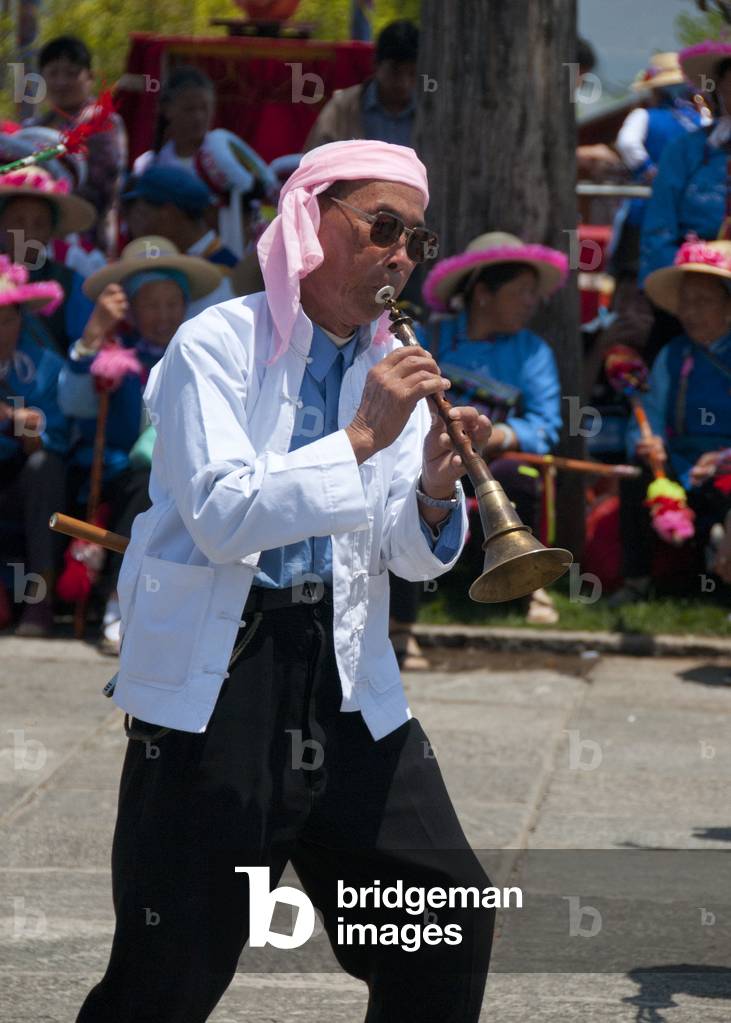 China: A Bai man plays a Chinese suona (oboe), Bai music and dance festival at Santa Si (Three Pagodas), Dali, Yunnan