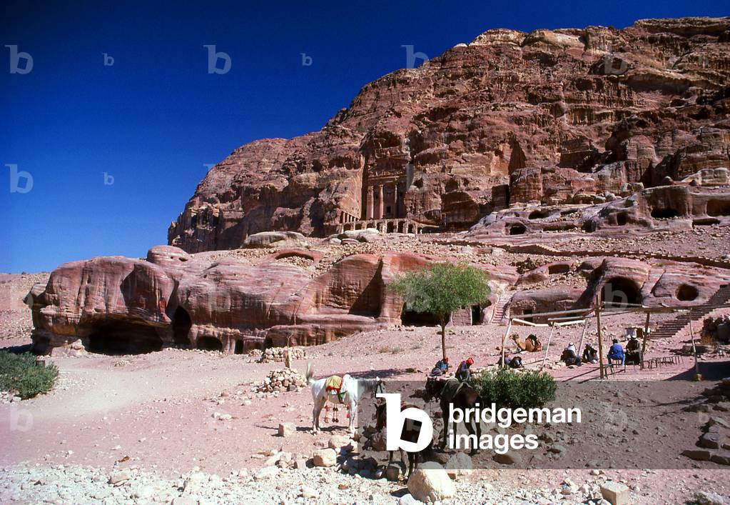 Jordan: Arab horsemen in front of The Urn Tomb, Petra