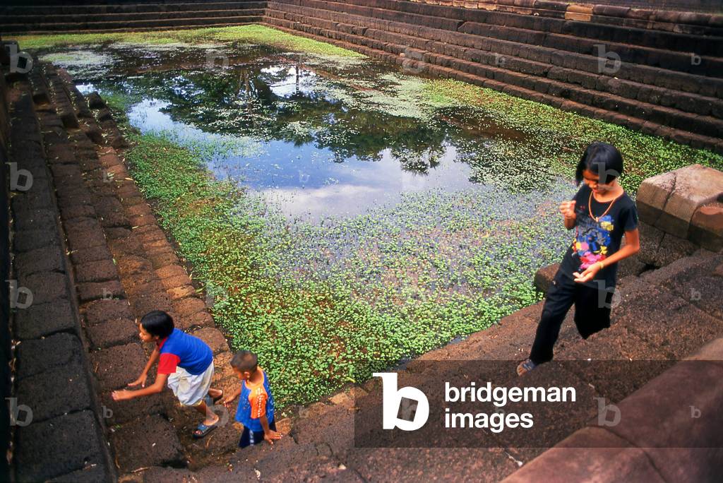 Thailand: Children play around one of the temple's tanks, Prasat Meuang Tam, Buriram Province, Northeast Thailand