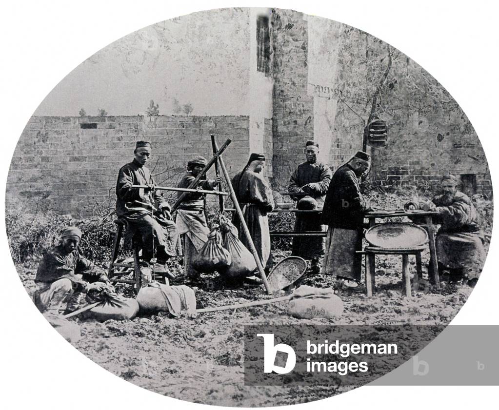 China: Weighing tea at a factory in Central China in about 1875.