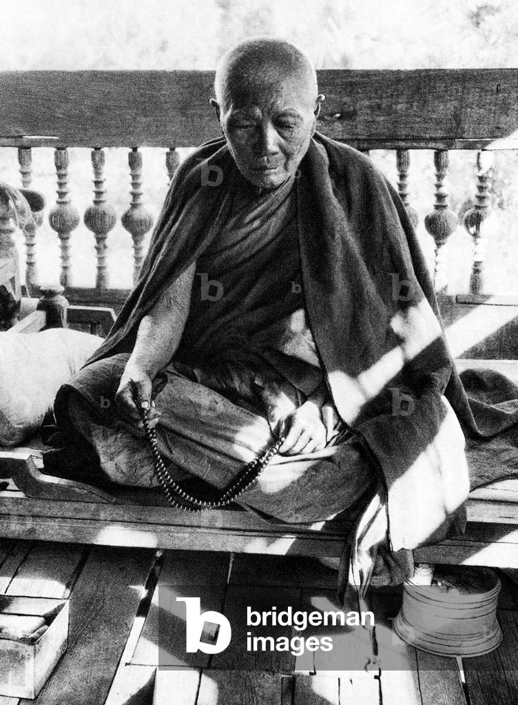 Burma/ Myanmar: An old Buddhist monk with prayer beads, c.1920s.