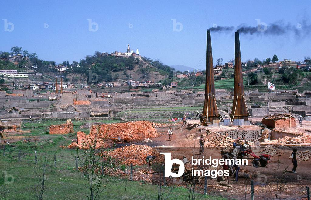 Nepal: Brick kilns on the outskirts of Kathmandu, with Swayambhunath (Monkey Temple) on a hill in the background, Kathmandu Valley