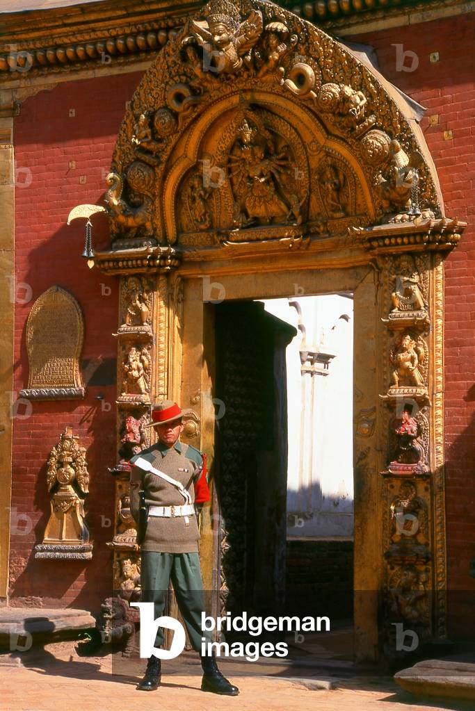 Nepal: A soldier guards the Golden Gate (Sun Dhoka) leading to the Taleju Temple within the Royal Palace complex, Bhaktapur, Kathmandu Valley (1997)