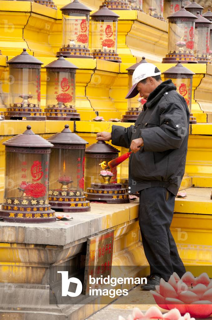 China: Pilgrims lighting candles at the Puxian statue, Golden Summit (Jin Ding), Emeishan (Mount Emei), Sichuan Province