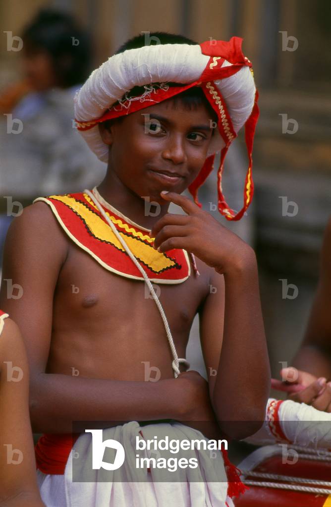 Sri Lanka: Traditional drummer boy at Kelani Temple near Colombo
