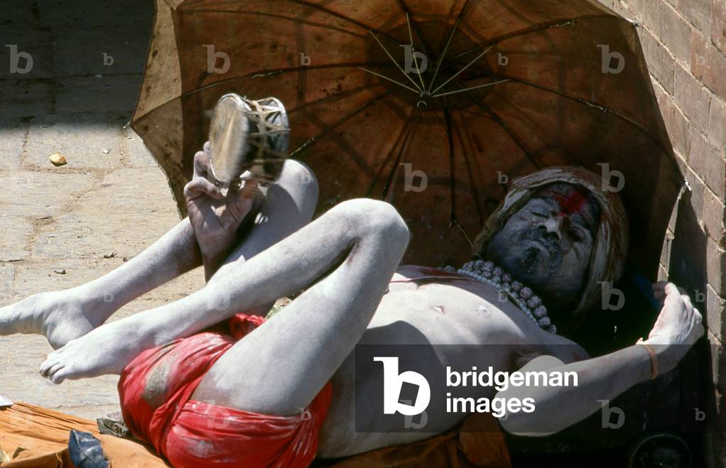 Nepal: Fakir shakes his tambourine on a Kathmandu street