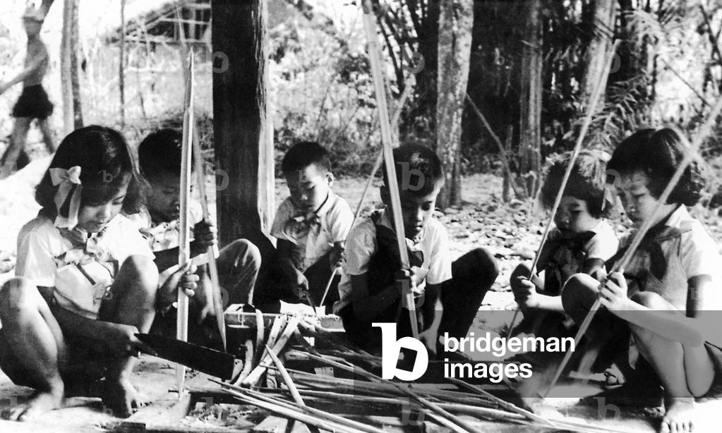 Vietnam: Children help whittle bamboo spikes, Cu Chi, South Vietnam, Second Indochina War (Vietnam War) (1968)