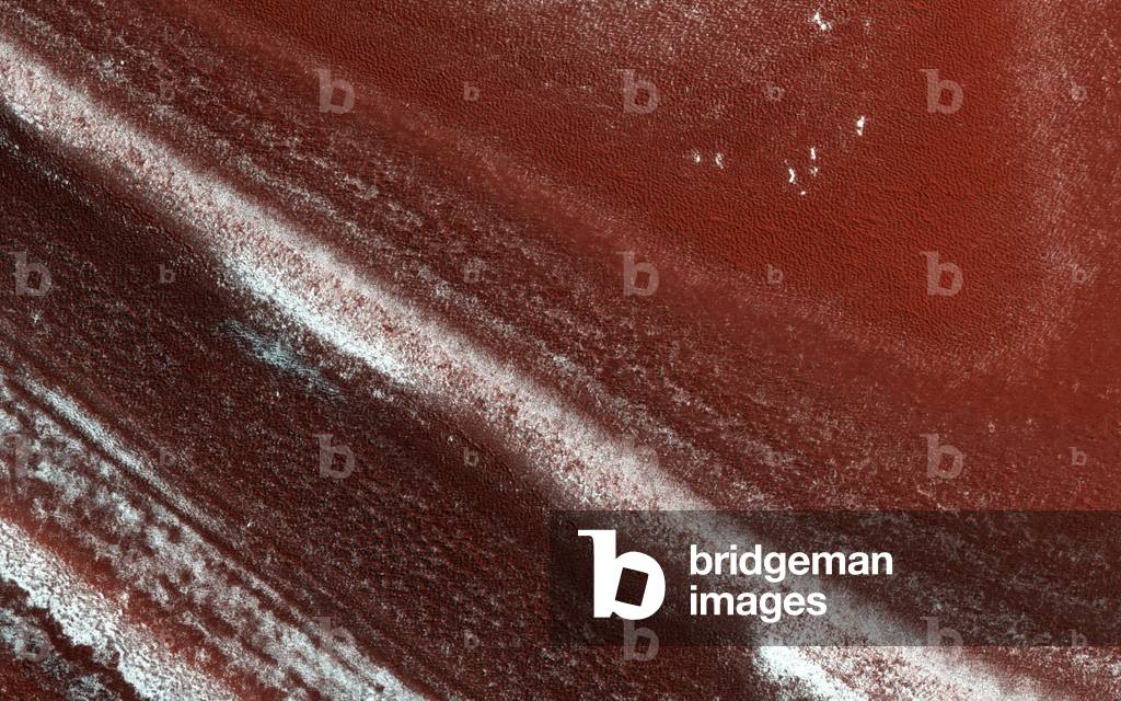 Laminate structures near the north pole on Mars - Layers Exposed at North Polar Cap on Mars: Laminated structures near the north polar cap of Mars. These different layers of ice and girders correspond to climatic variations over the last ten thousand years. Image obtained on 18 April 2016 by the HIRISE camera on board the Mars Reconnaissance orbiter probe. HIRISE is a 50 cm telescope that observes visible and near infrared. At the edge of Mars' permanent North Polar cap, we see an exposure of the internal layers, each with a different mix of water ice, dust and dirt. These layers are believed to correspond to different climate conditions over the past tens of thousands of years. When we zoom in closer, we see that the distinct layers erode differently. Some are stronger and more resistant to erosion, others only weakly cemented. The strong layers form ledges