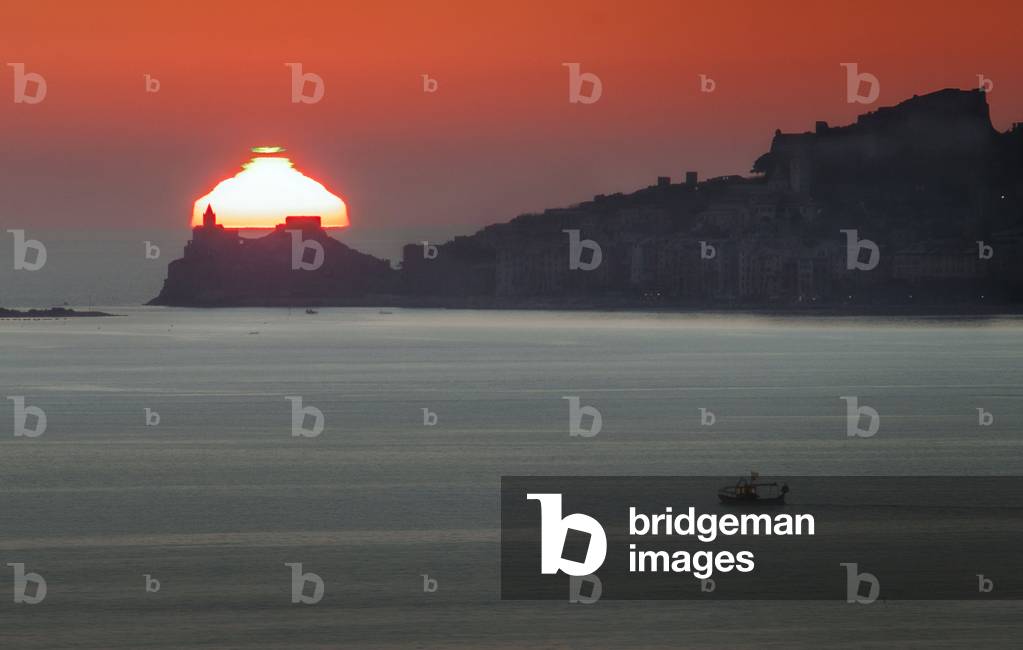 Sunset and Green Ray - Distorted Green Flash Sunset over Italy - Green ray obtained during a sunset with the Church of San Pietro in the foreground. Image obtained in February 2015 from Porto Venere in Italy. Green flash during a sunset. This image was taken in February 2015 from Porto Venere, Italy, with San Pietro church situated in the foreground