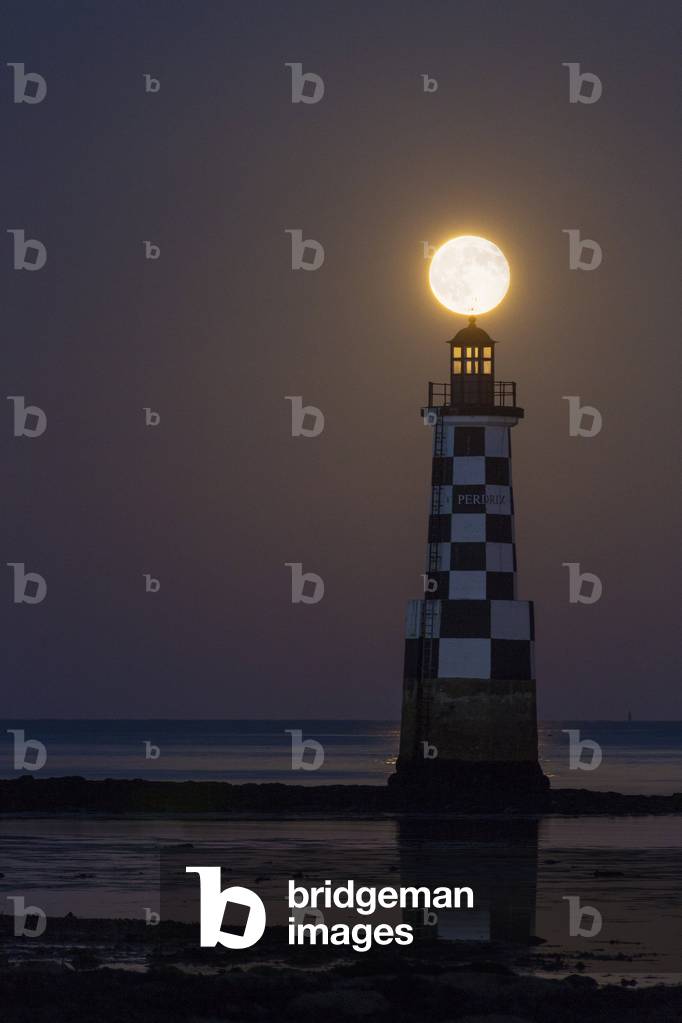 Full moon above the Pardrix lighthouse in Finistere (between Tudy Island and Loctudy). 24 June 2013, Brittany, France