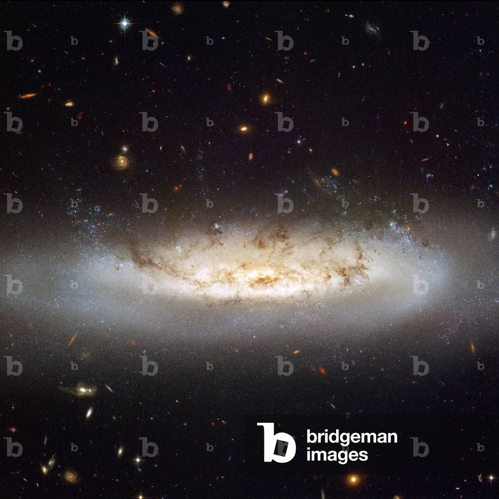 Spiral Galaxy NGC 4522 - Galaxy Spiral NGC 4522 - Moving at a speed of 10 million km/h in the Virgin's galaxy cluster, this spiral galaxy loses some of its gas. NGC 4522 is located about 60 million light years away from Earth. Image obtained by the Hubble Space Telescope. NGC 4522 is a spectacular example of a spiral galaxy that is currently being stripped of its gas content. The galaxy is part of the Virgo galaxy cluster and its rapid motion within the cluster results in strong winds across the galaxy as the gas within is left behind. Scientists estimate that the galaxy is moving at more than 10 million kilometers per hour. A number of newly formed star clusters that developed in the stripped gas can be seen in the Hubble image. The stripped spiral galaxy is located some 60 million light - years away from Earth
