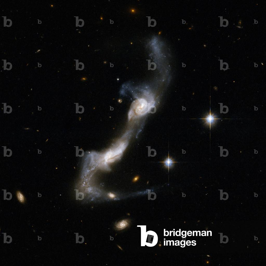 Interacting galaxies UGC 8335 in the Great Bear - Interacting galaxies UGC 8335 in Ursa Major - The galaxy UGC 8335, also called Arp 238, is located about 400 million years away from Earth. It's a pair of spiral galaxies interacting. Regions of intense star formations appear in blue. Image obtained by the Hubble Space Telescope on May 10, 2002. UGC 8335 (Arp 238) is a strongly interacting pair of spiral galaxies resembling two ice skaters. The interaction has united the galaxies via a bridge of material and has yanked two strongly curved tails of gas and stars from the outer parts of their bodies. Both galaxies show dust lanes in their centers. UGC 8335 is located in the constellation of Ursa Major, the Great Bear, about 400 million light - years from Earth. Image taken by the Hubble space telescope on May 10, 2002