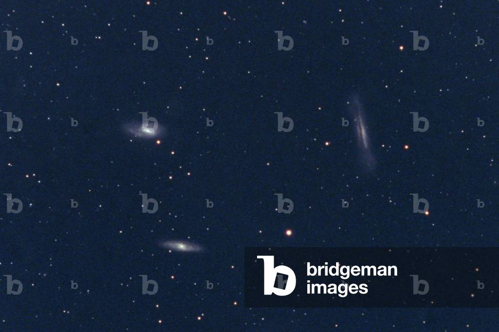 Lion Triplet (spiral galaxies M65 - M66 - NGC 3628) - Trio of Galaxies in Leo M65, M66, NGC 3628 - M66, with its neighbors M65 and NGC 3628, forms a remarkable triplet of galaxies, called the Lion Triplet or the M66 Group, located at a distance of about 35 million years - light. All three are spiral galaxies. Image obtained in 1998 with an amateur instrument, a 130 mm bezel. This trio of galaxies in Leo is located at a distance of about 35 million light years. M66 is at upper left, M65 is below it at lower right, and NGC 3628 is at right. All are normal spiral galaxies, but NGC 3628 is seen edge - on, with a prominent dust lane obscuring the central portion of the galaxy