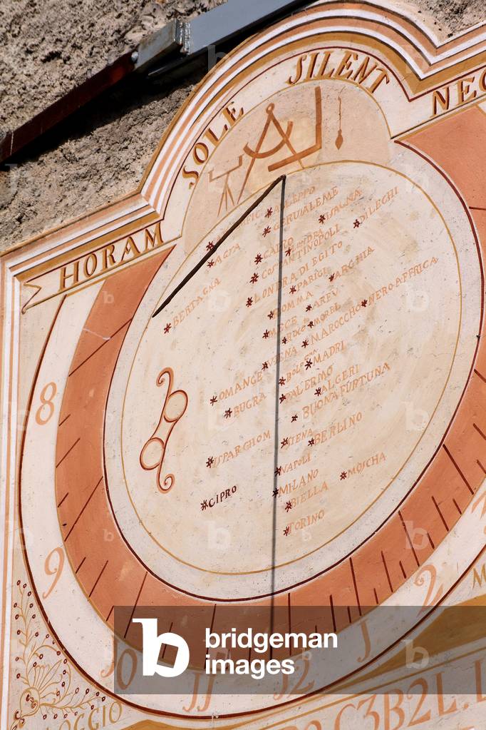 Sundial - Eglise d'Entraigues - Dial realized in 1843, restored in 1999. The central part indicates the solar noon of 37 places in the world, each represented by a red celestial star. The Latin motto means I refuse to say the time if the sun is silent. Hameau d'Entraigues, Saint Jean d'Arves, Savoy