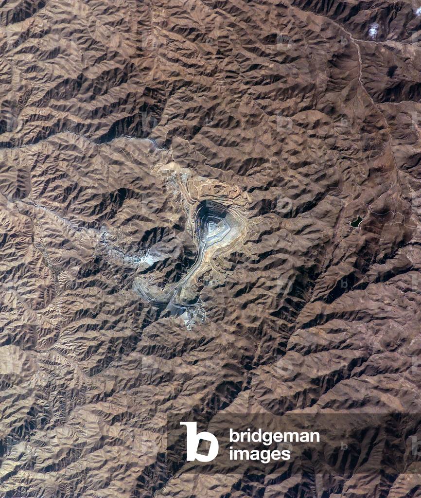 Toquepala Copper Mine - Peru - Toquepala Copper Mine - Southern Peru: The Toquepala mine in southern Peru is a large open-pit copper mine. Image taken from the International Space Station (ISS) on 22 September 2003. The rugged, mineral-rich Andes supports some of the world's biggest mines (gold, silver, copper, and more). This image looks down the bull's-eye of Peru's Toquepala copper mine, a steep sided and stepped open-pit mine. At the surface the open pit is 6.5 km across and it descends more than 3000 m into the earth. Astronaut photograph was acquired on September 22 2003 from the International Space Station (ISS)