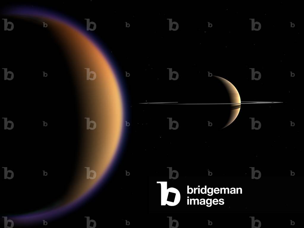 Saturn and Titan - Illustration - Saturn from Titan orbit - The planet Saturn seen from the orbit of its Titan satellite. This is how Saturn and Titan might look from a position in orbit around Titan. While in reality Saturn is vastly larger than Titan, it appears smaller here because Titan's orbit puts Saturn at a distance of about 700 thousand miles. Sunlight filtering through Titan's upper atmospheric haze - - extending over 300 miles above the surface - - gives a bluish cast to its limb